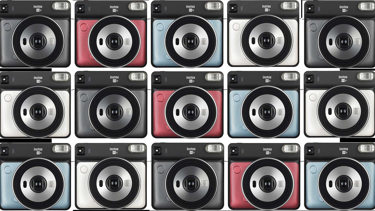 A grid made of Fujifilm Instax cameras on a plain background