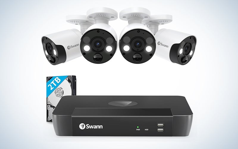 Swannâs 8-Channel/4-Camera Home Security Camera System with four cameras over a white background